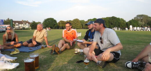 Anson players and supporters sit on the grass after the game at Harrow Lodge and enjoy a beer